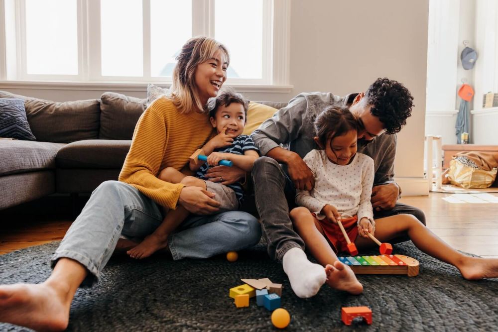 Family playing on the living room floor