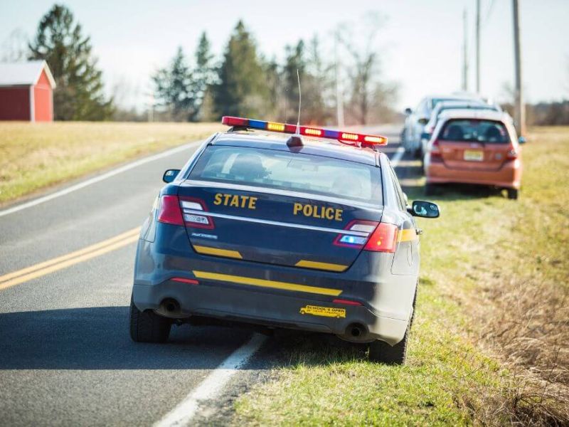 image of police vehicle on side of the road representing what a traffic stop can look like on the roadway