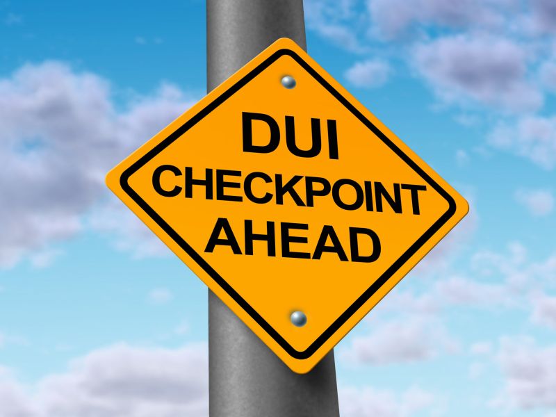 image of sobriety and drunk driving checkpoint representing the dangers of drivers that are intoxicated above the legal limit by alcohol or other drugs while they are behind the wheel of a vehicle.