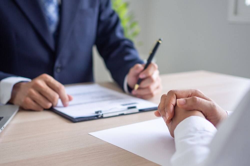 image of person sitting at desk reviewing documents