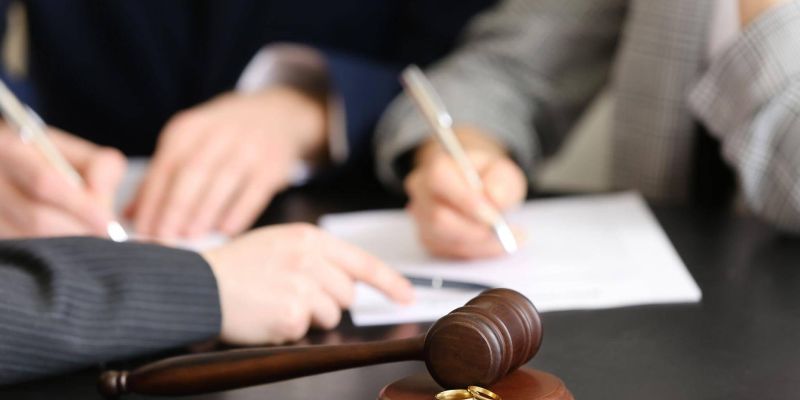 two people sitting at a table with a judge's gavel