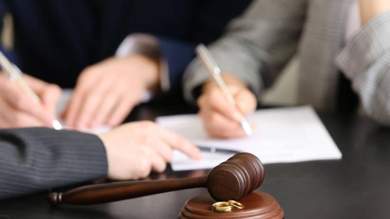 two people sitting at a table with a judge's gavel