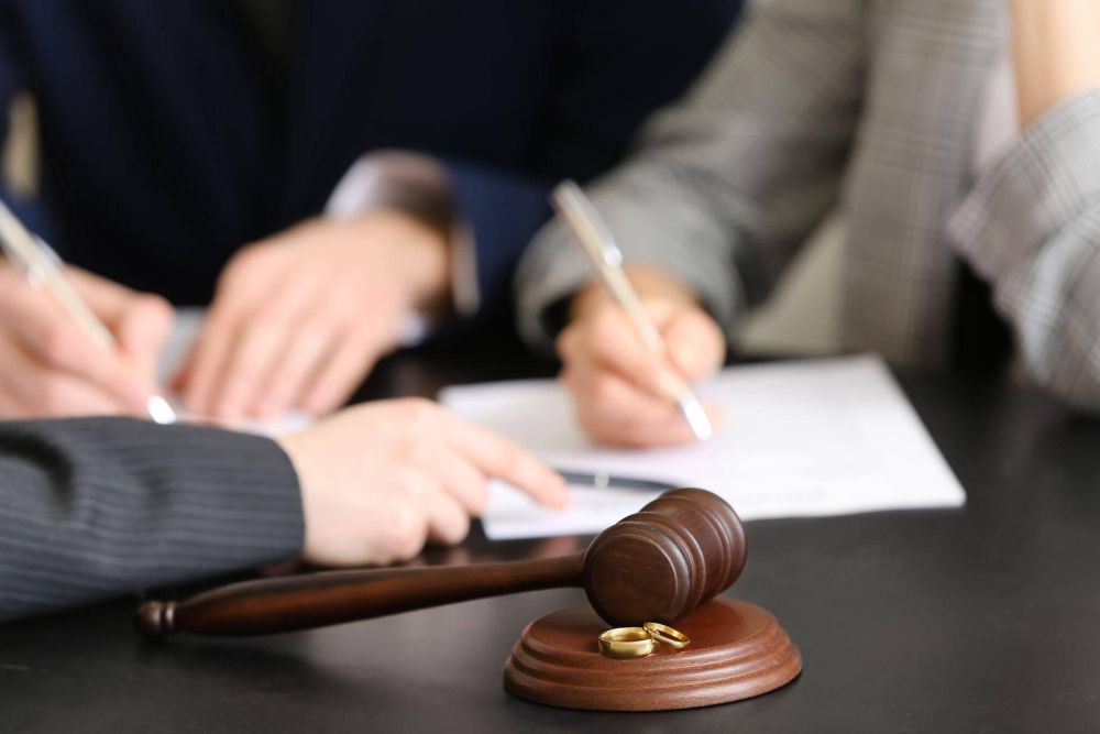 two people sitting at a table with a judge's gavel