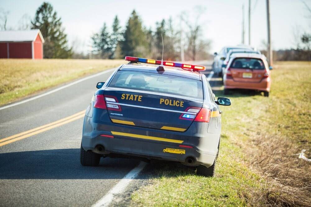image of police vehicle on side of the road representing what a traffic stop can look like on the roadway