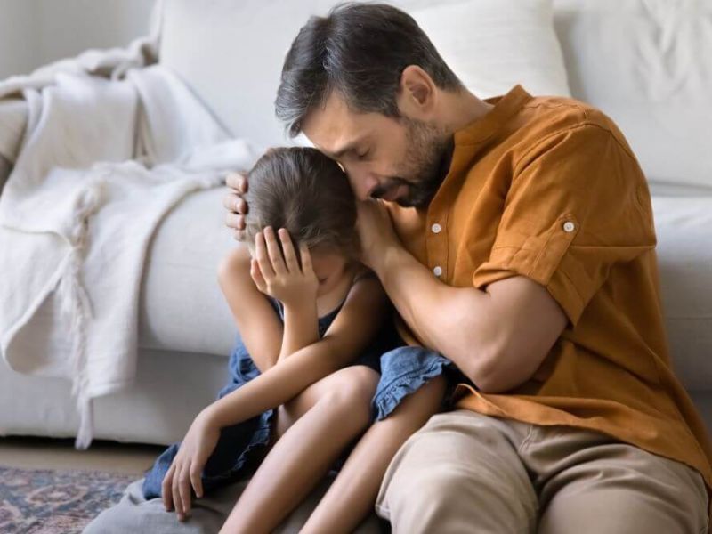 Father consoling his daughter