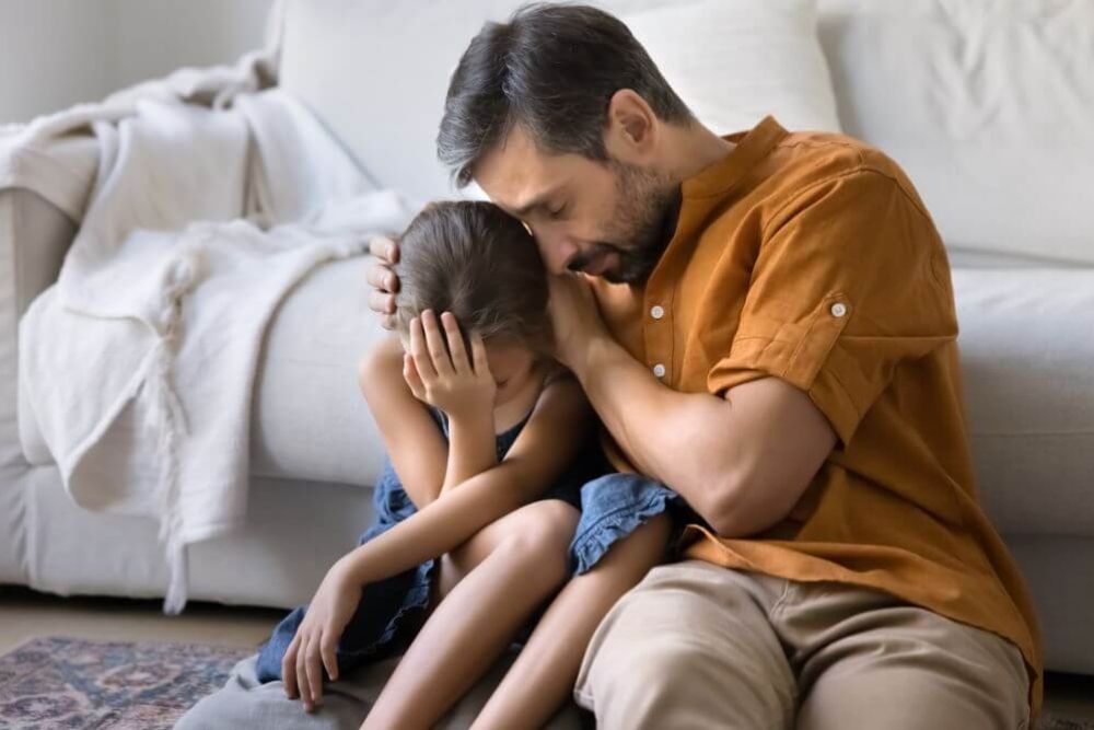 Father consoling his daughter