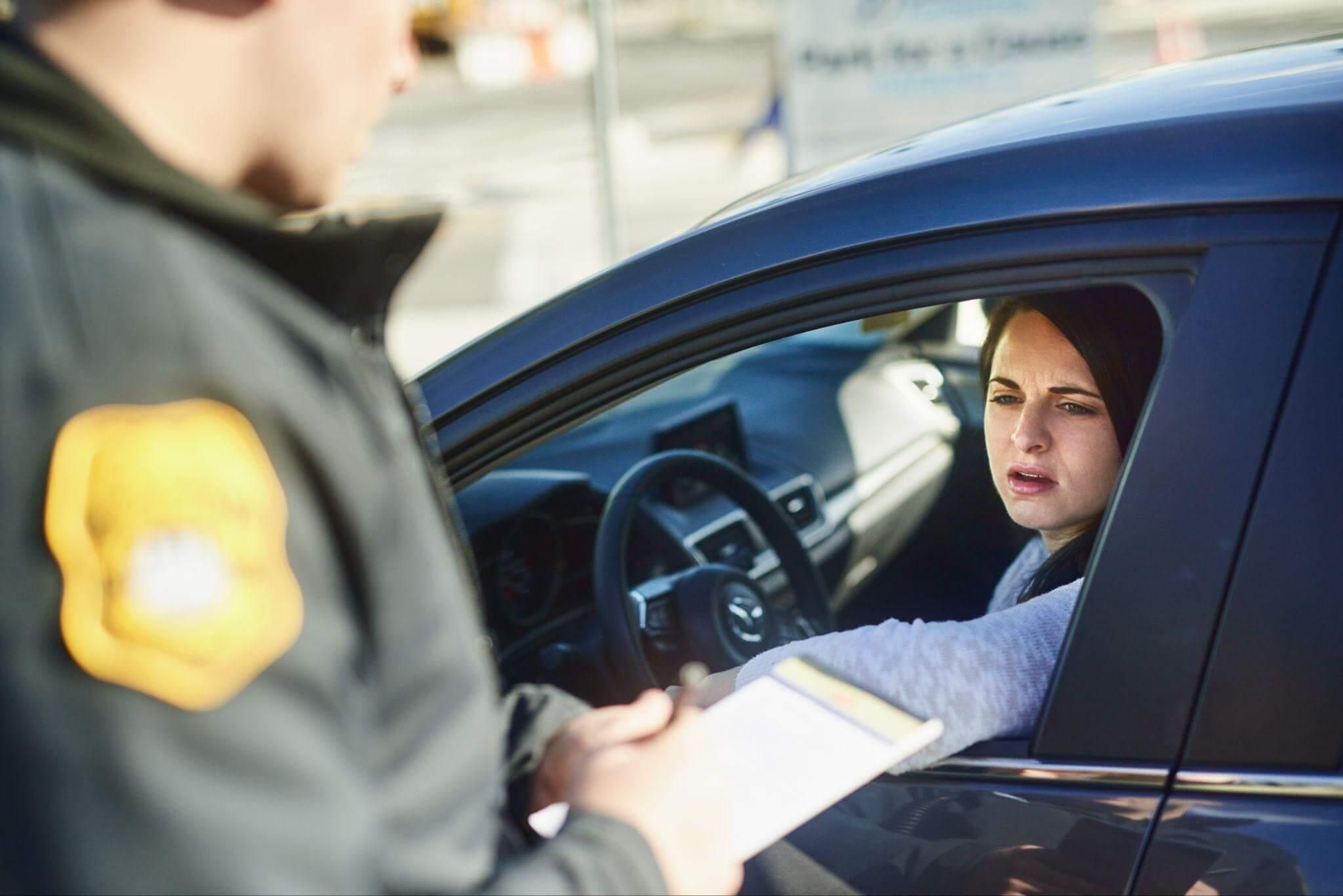 a woman in a police uniform sitting in a car