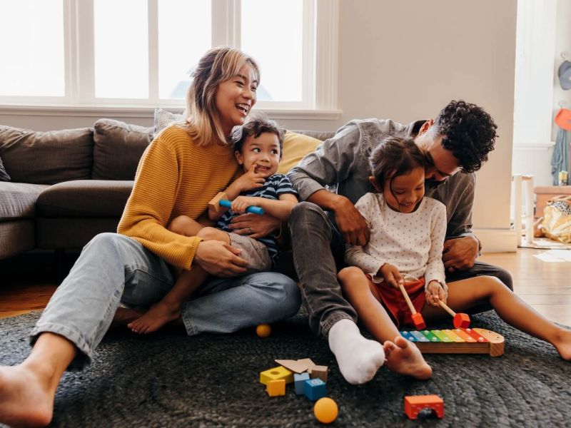 Family playing on the living room floor