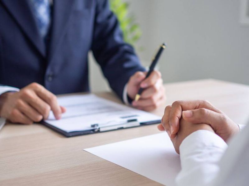 image of person sitting at desk reviewing documents