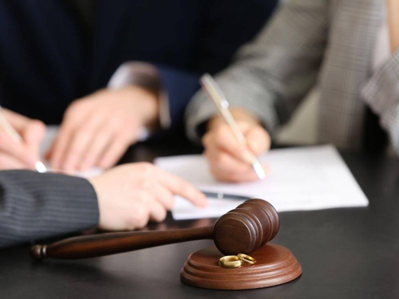 two people sitting at a table with a judge's gavel