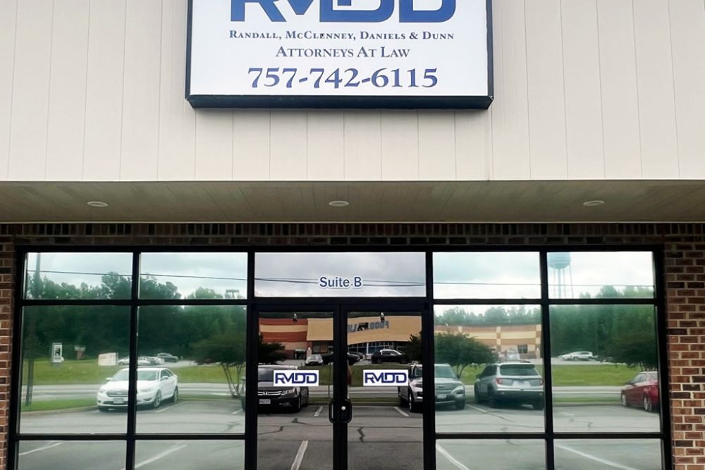 Front entrance of a law office building with a sign above reading Attorneys at Law and Suite B on the door.