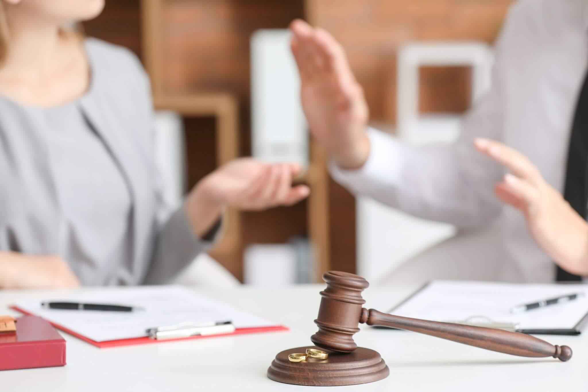 a couple are fighting while sitting in front of a judge's table
