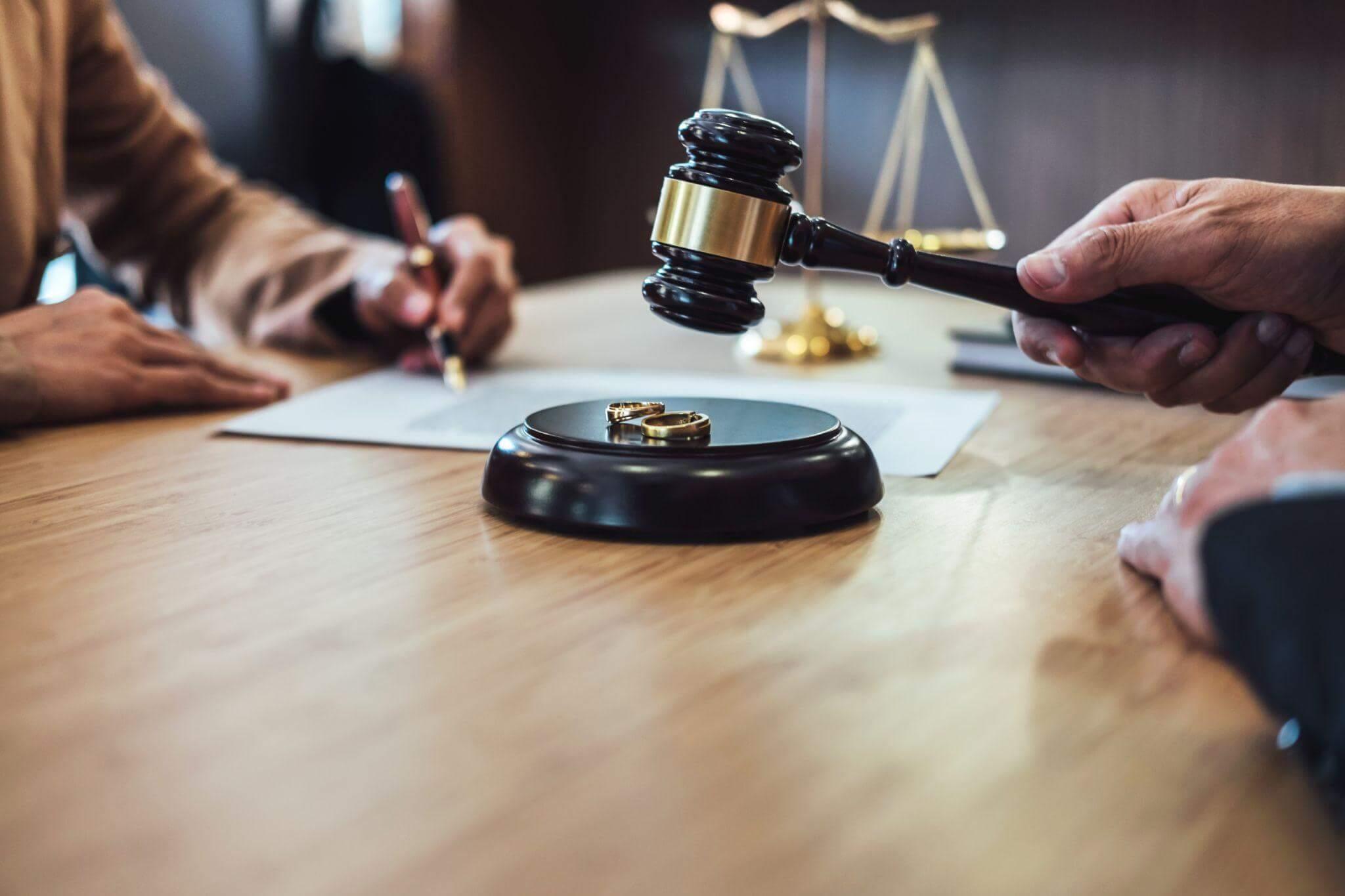 a wooden table with a judge dictating sentence on a marriage issue